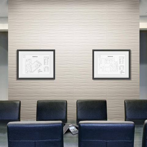 Office conference room with wavy tile accent wall, a long table wtih leather chairs, and a some framed building maps on the wall