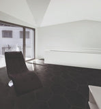 hexagon tile in black with single black chair. 