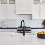 White gloss Concerto wall tile set brick on a backsplash in a largely white kitchen