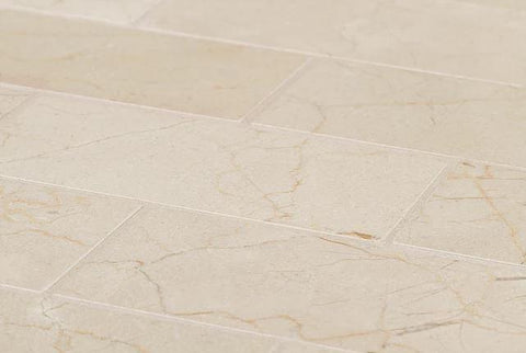 Honed marble tile in brick mosaic and natural tones as flooring