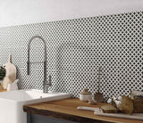 Gray geo porcelain pattern tile on the backsplash of a modern kitchen area with bread.