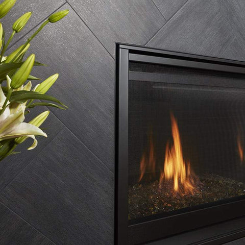 Metalwood tile in the color Carbonio set herringbone around a fireplace insert