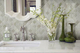 Bathroom with gray, polished tile wall, clean white countertops, and flower vases